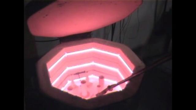 The red interior of a hot kiln furnace containing ultra high alumina ferrules.